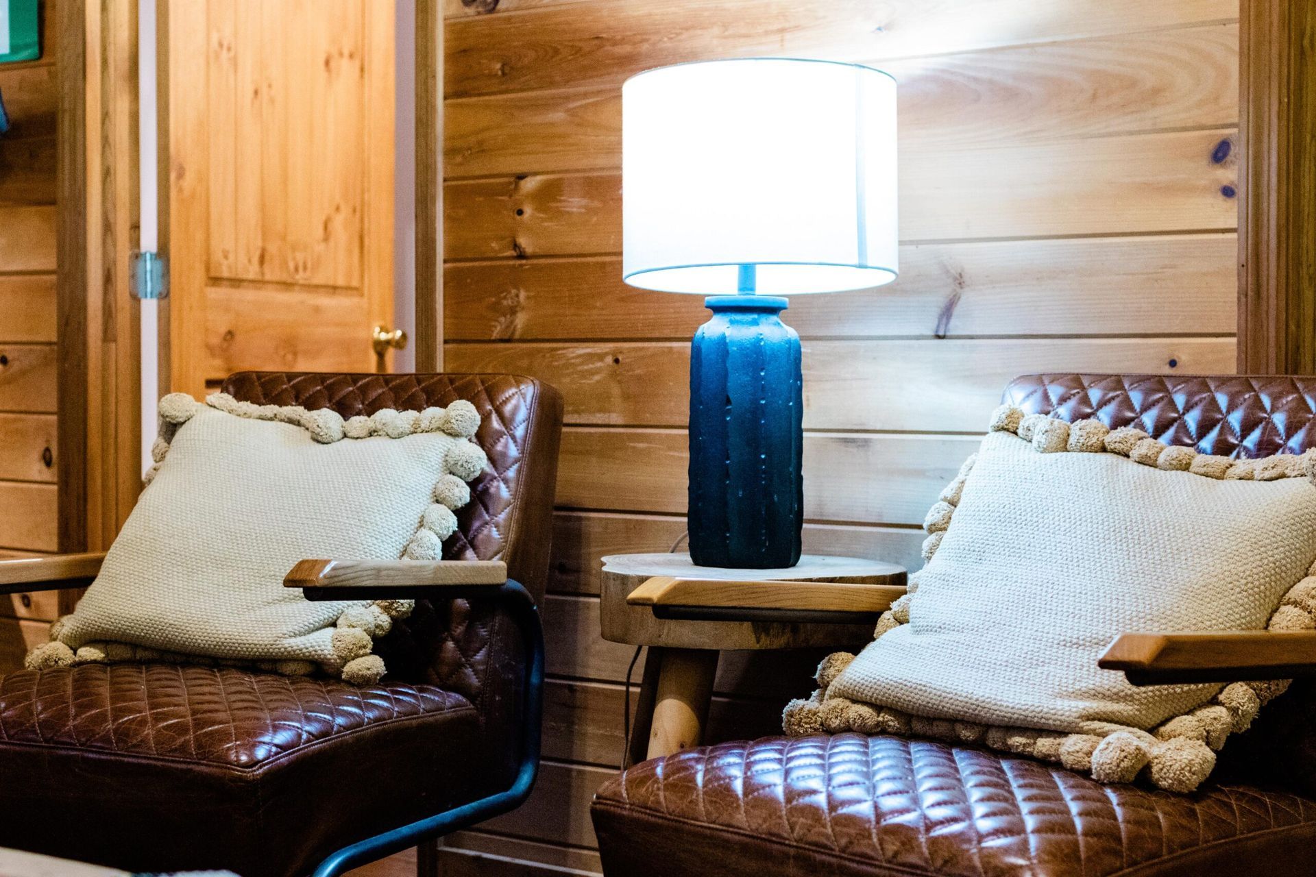 There are two chairs and a lamp in the room.