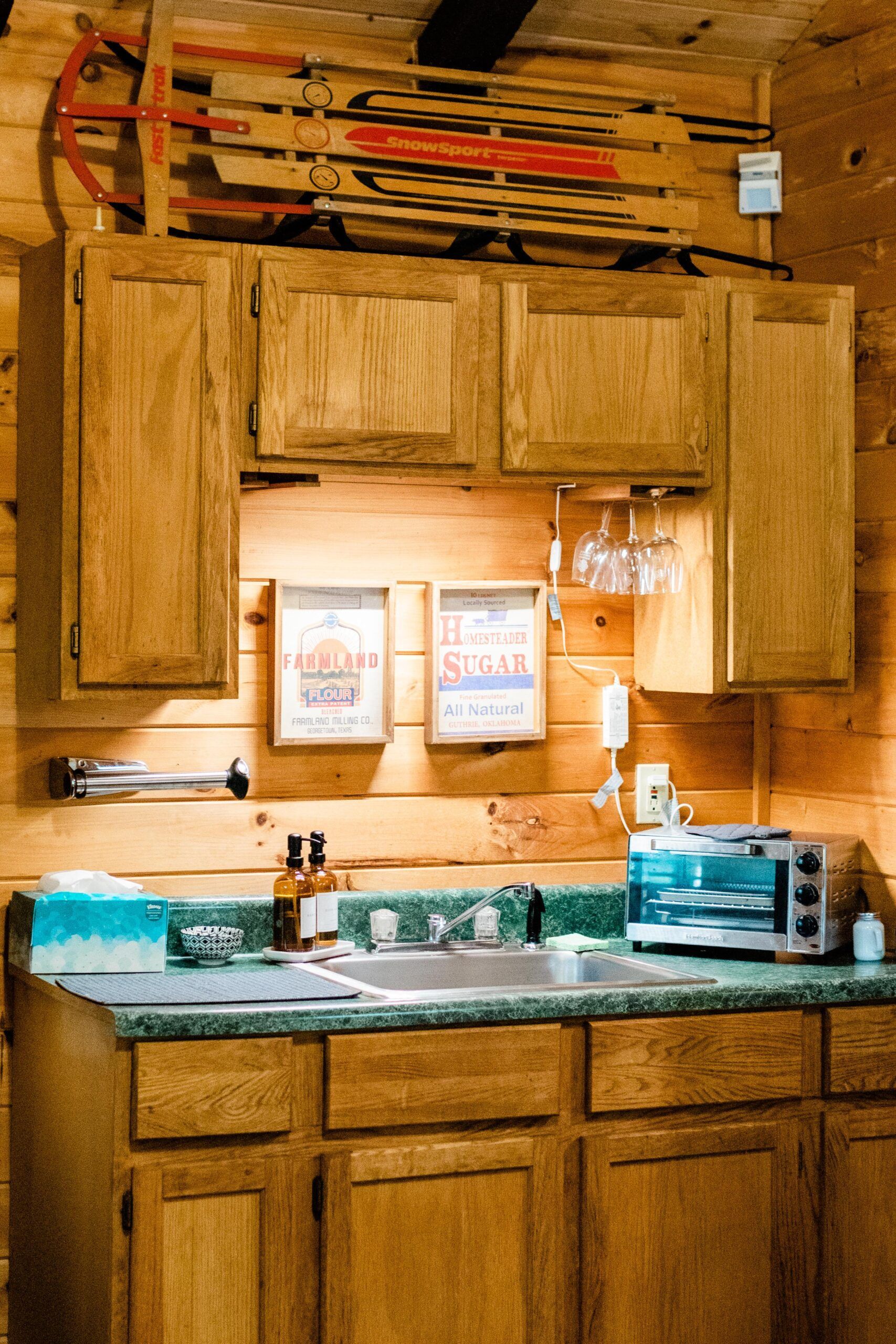 A kitchen with wooden cabinets and a sink