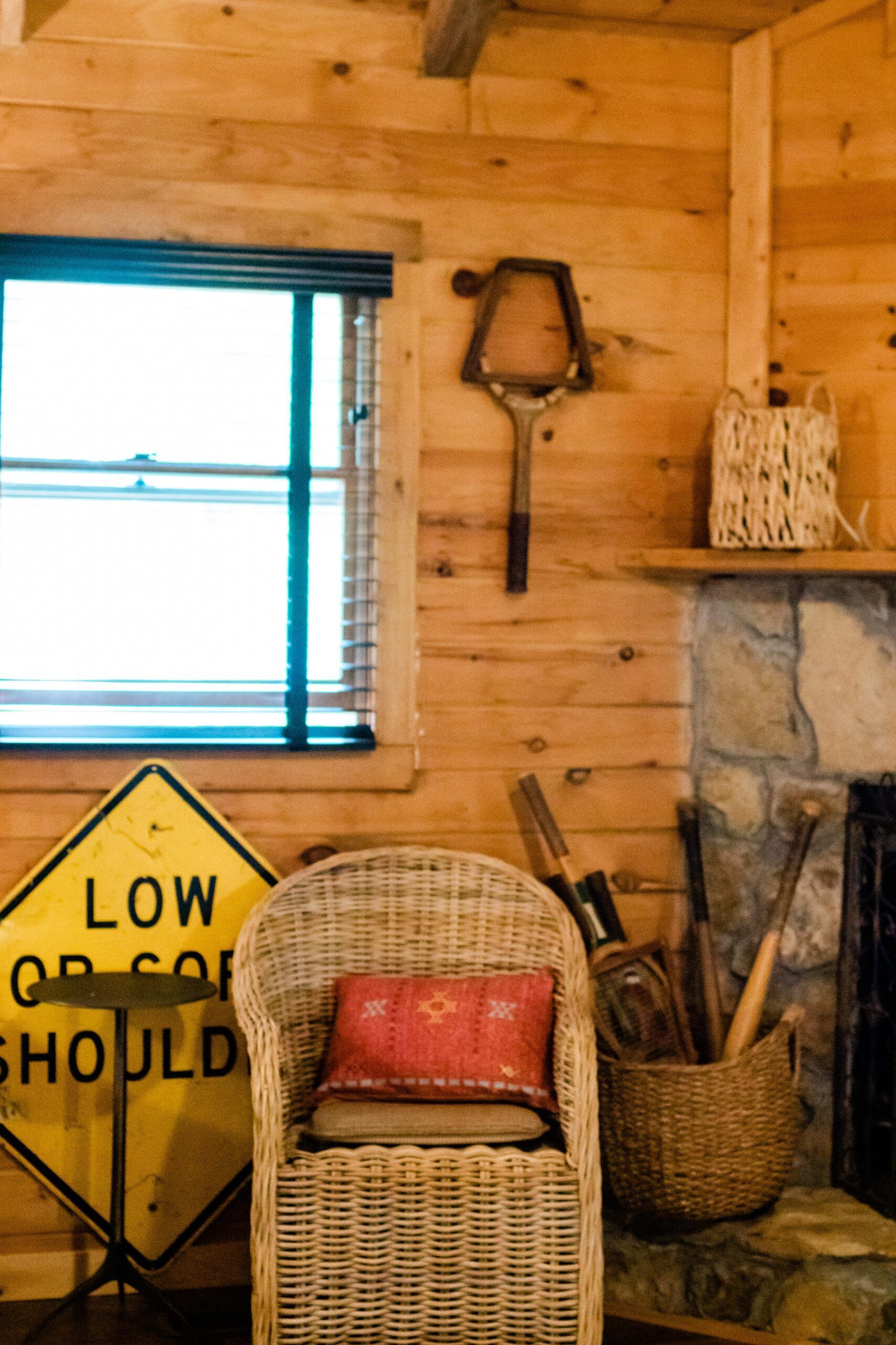 A wicker chair sits next to a sign that says low or could