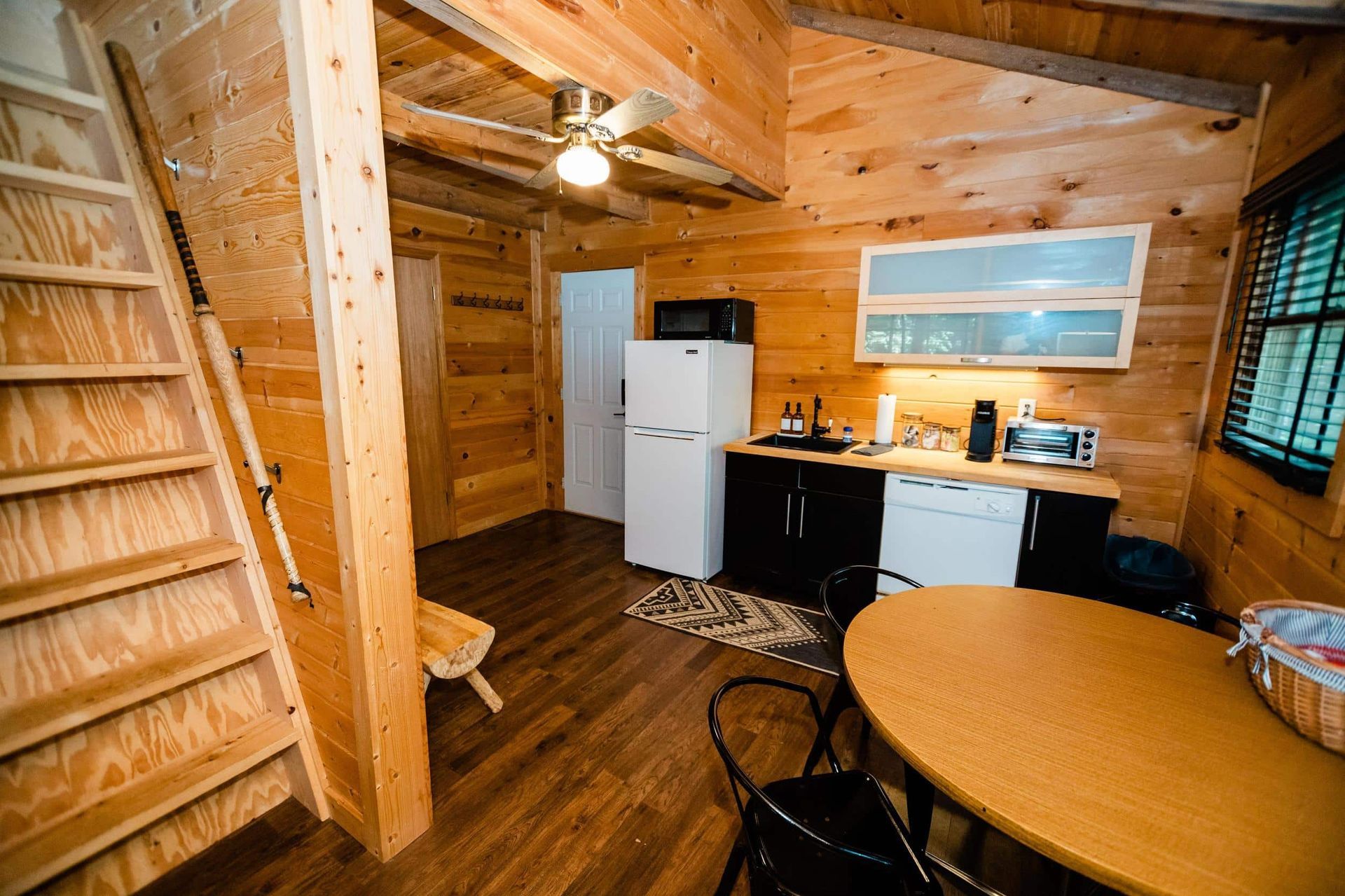 There is a staircase leading up to the second floor of the cabin.