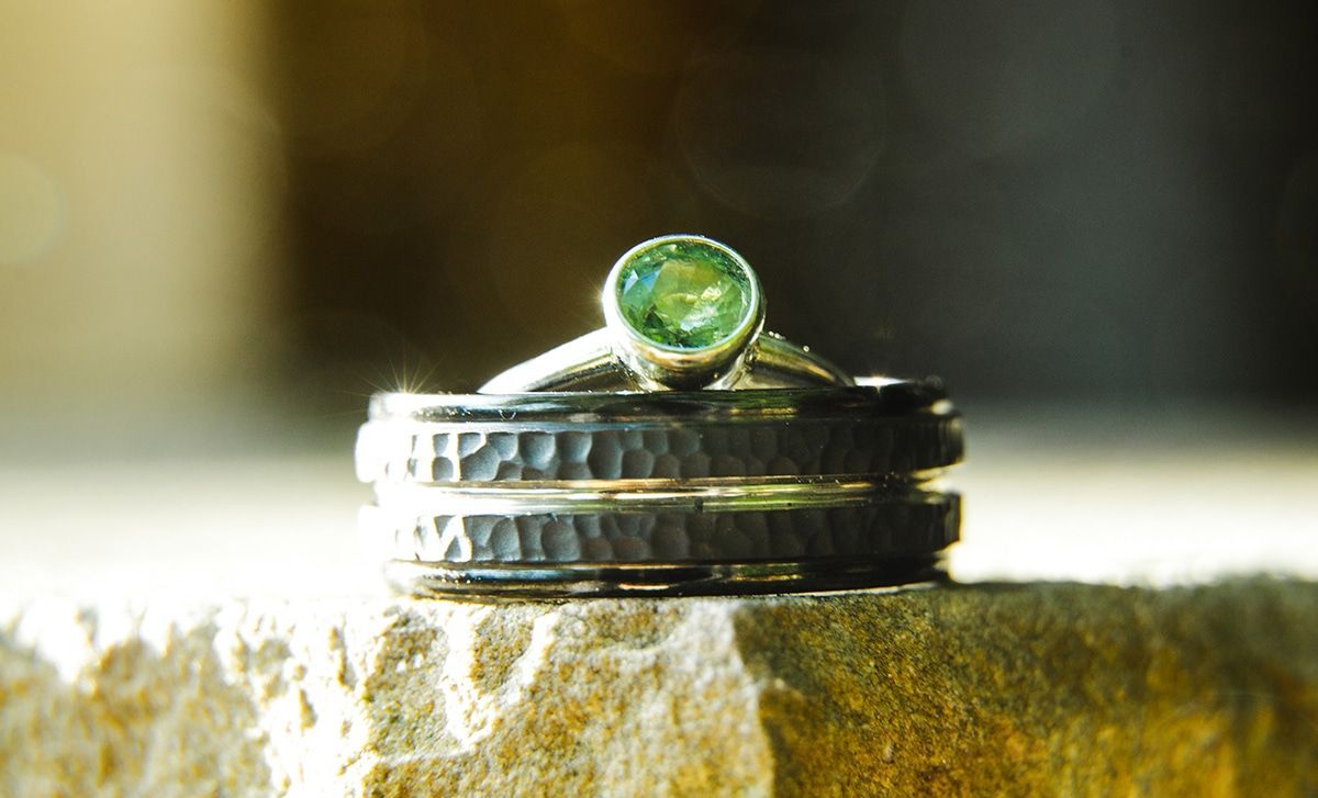 A couple of rings stacked on top of each other on a rock.
