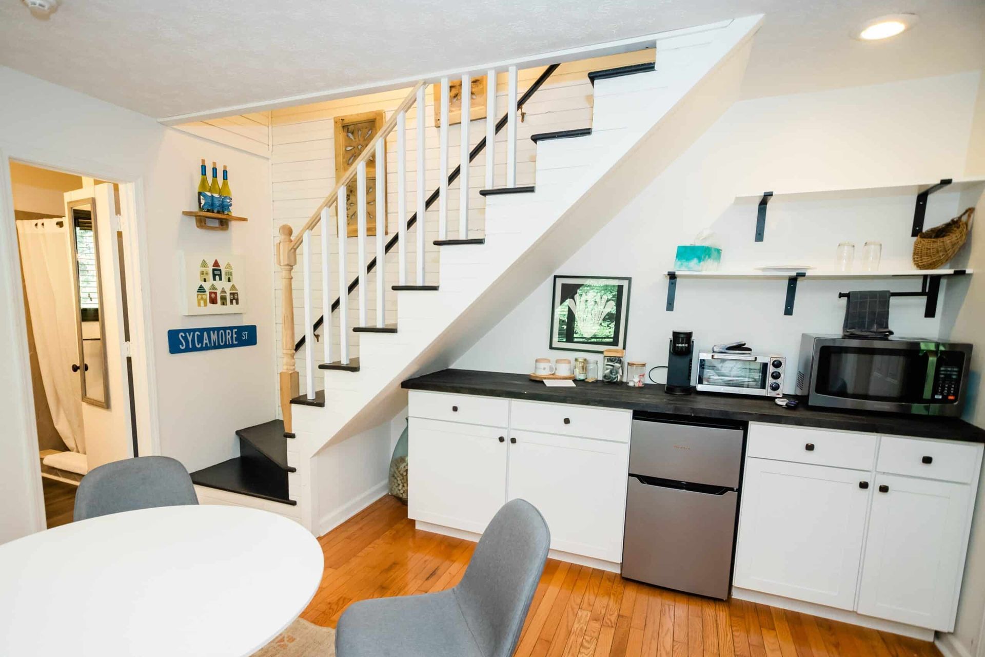 A kitchen with stairs leading up to the second floor