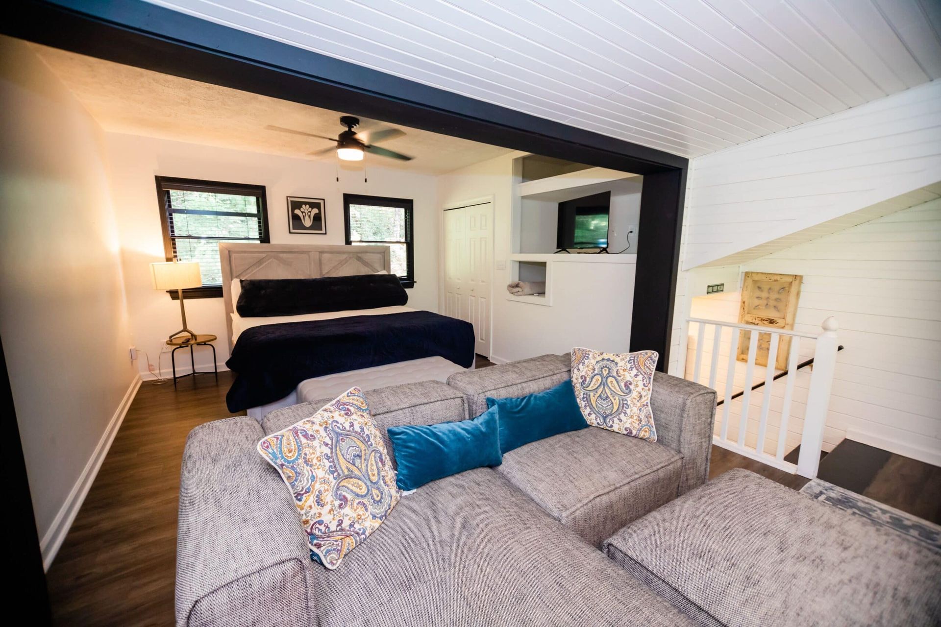 A living room with a couch and a bed in it.