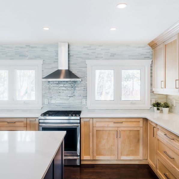 A kitchen with stainless steel appliances and wooden cabinets