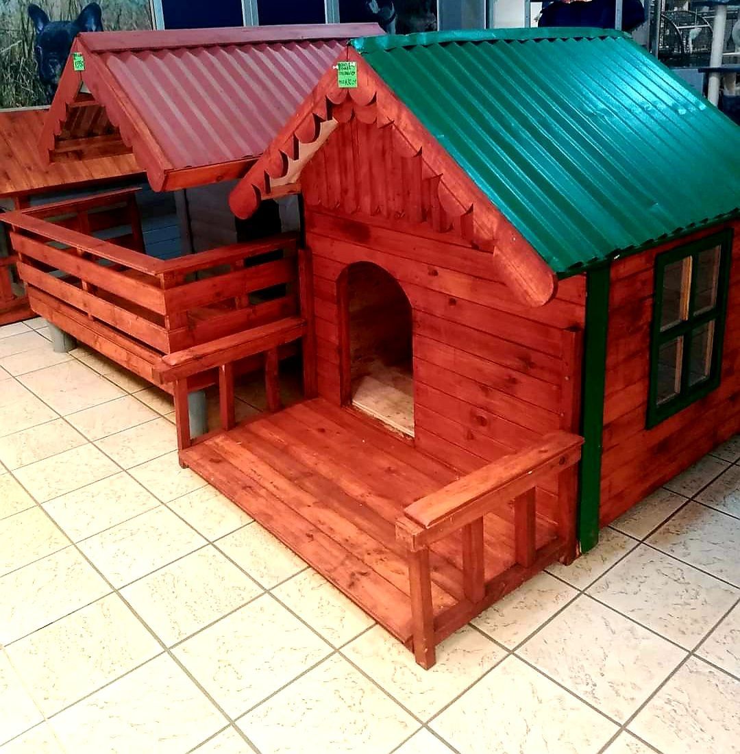 A wooden dog house with a green roof from Pets and the City in Pretoria East.