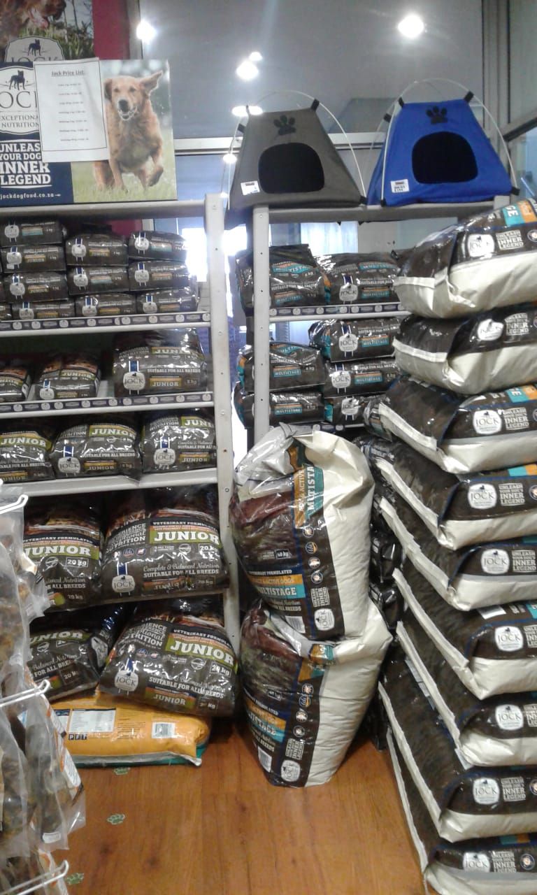 A bunch of bags of dog food are stacked on top of each other Pets and the City in Pretoria East.