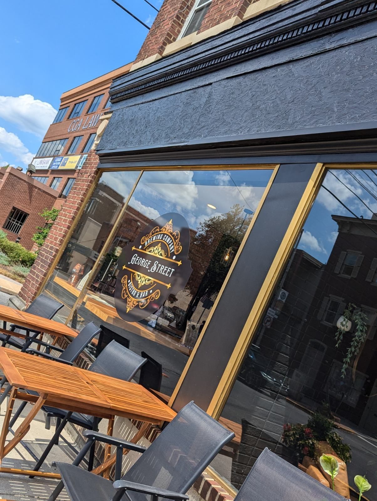 A restaurant with tables and chairs outside of it.