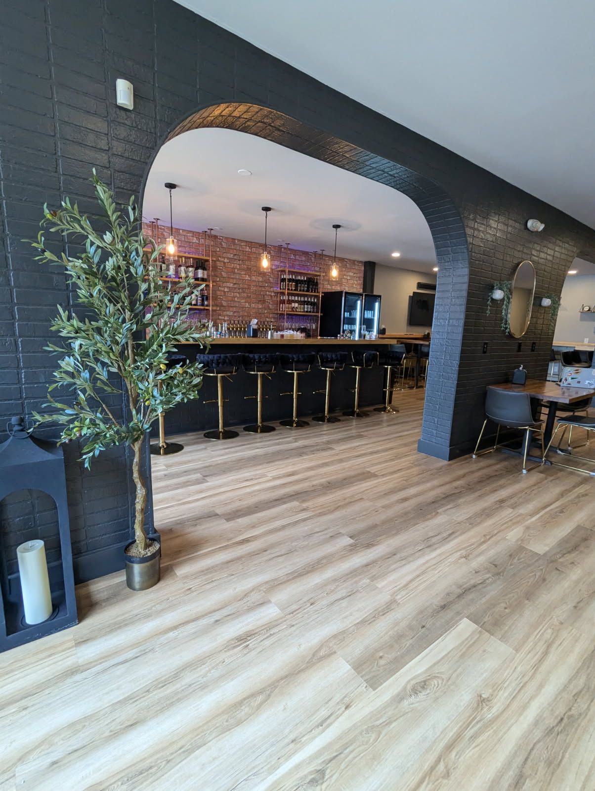 A large room with a wooden floor and a brick wall.