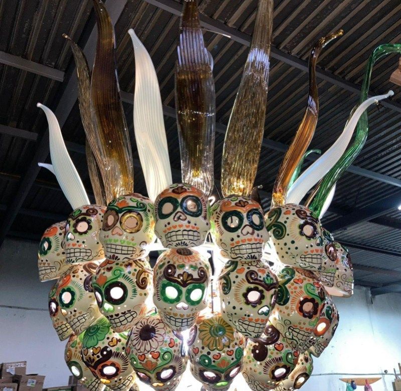 A bunch of sugar skulls are hanging from the ceiling