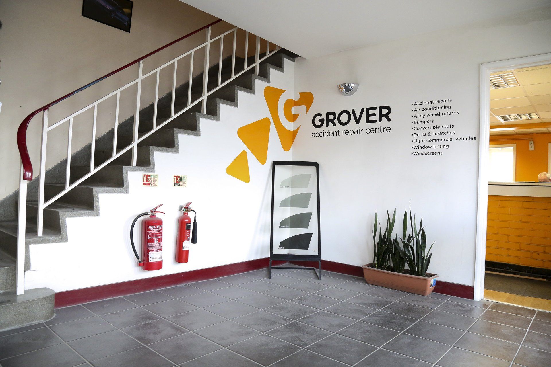 A staircase with a sign on the wall that says grover
