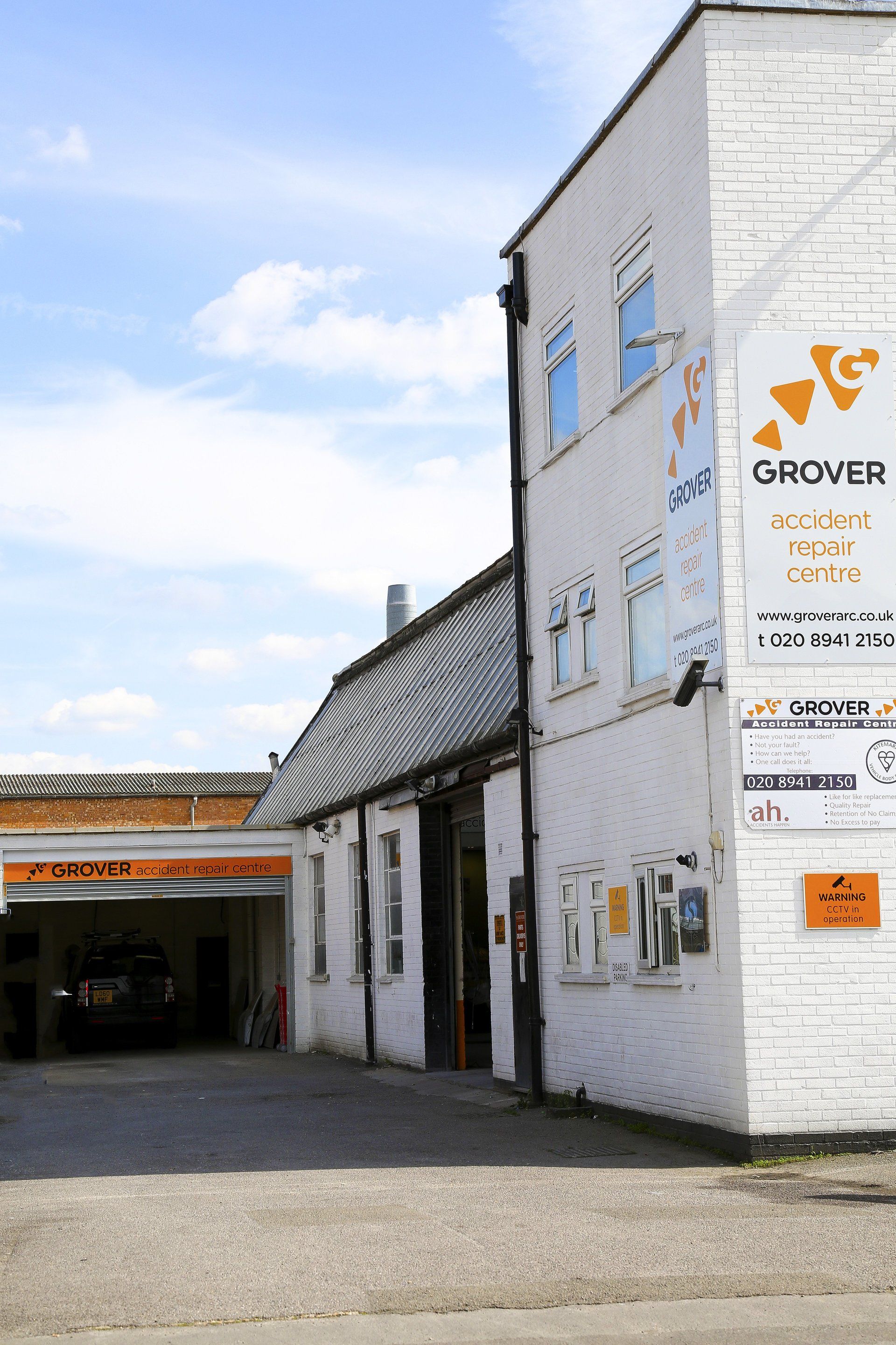 A white building with a sign that says grover on it