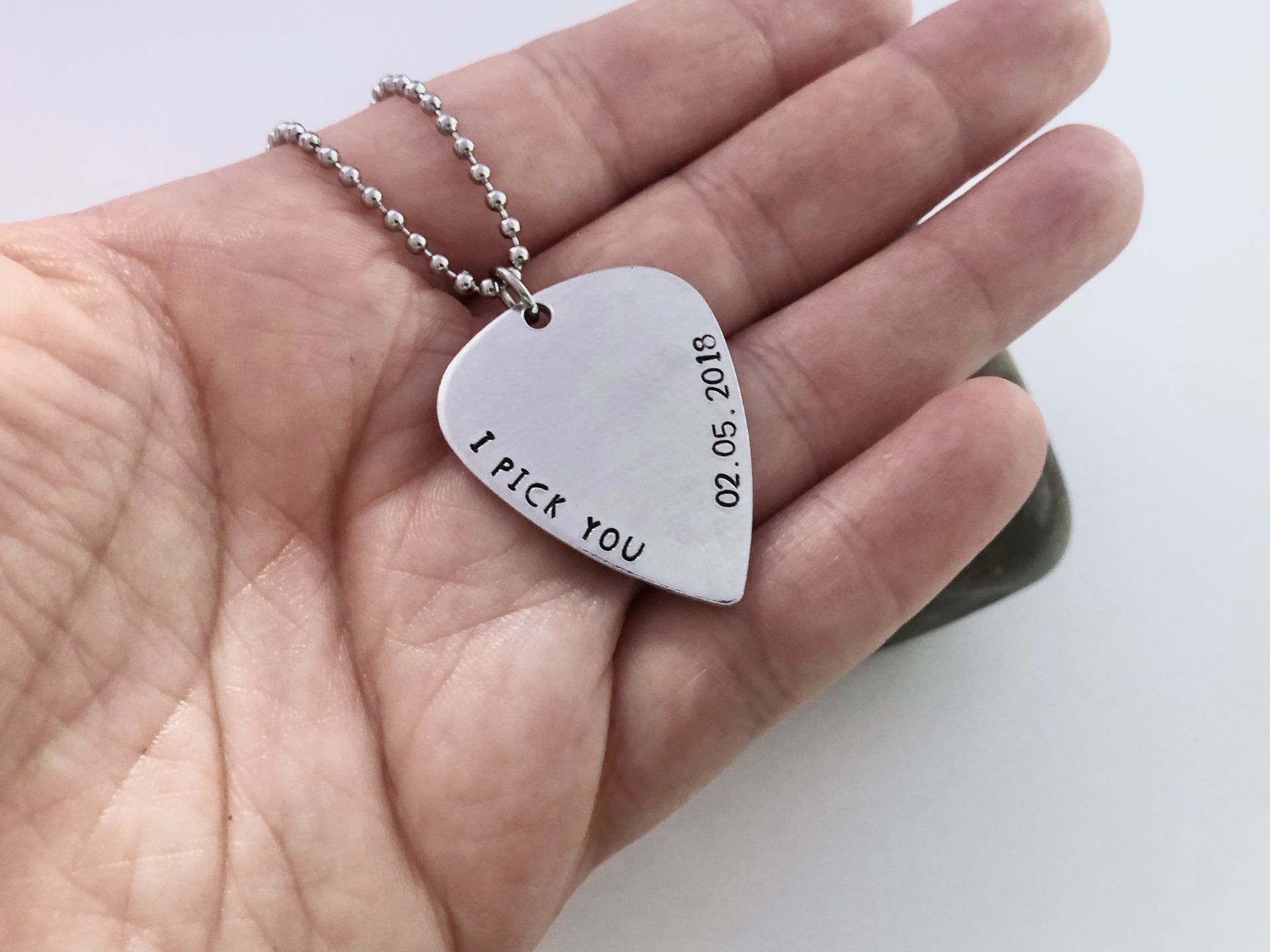 Silver guitar pick necklace with 