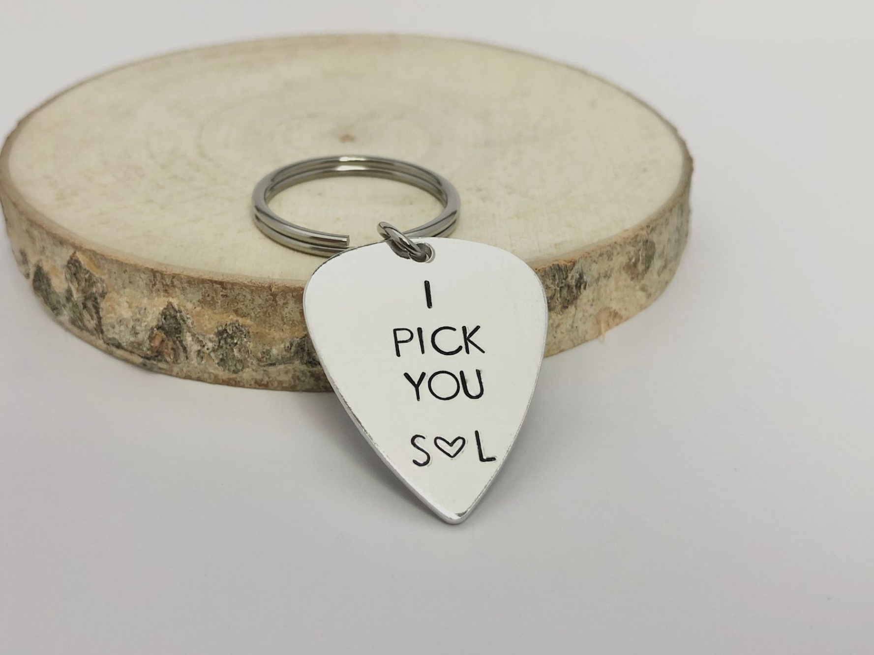Silver guitar pick keychain engraved with 