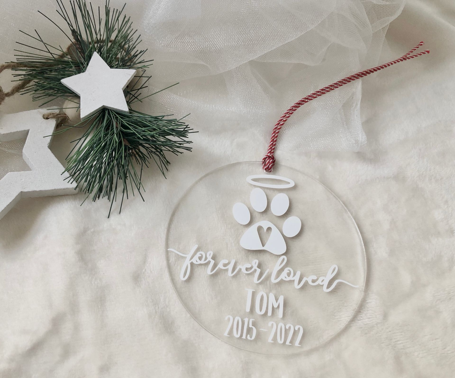 Clear ornament with paw print, angel halo, and 