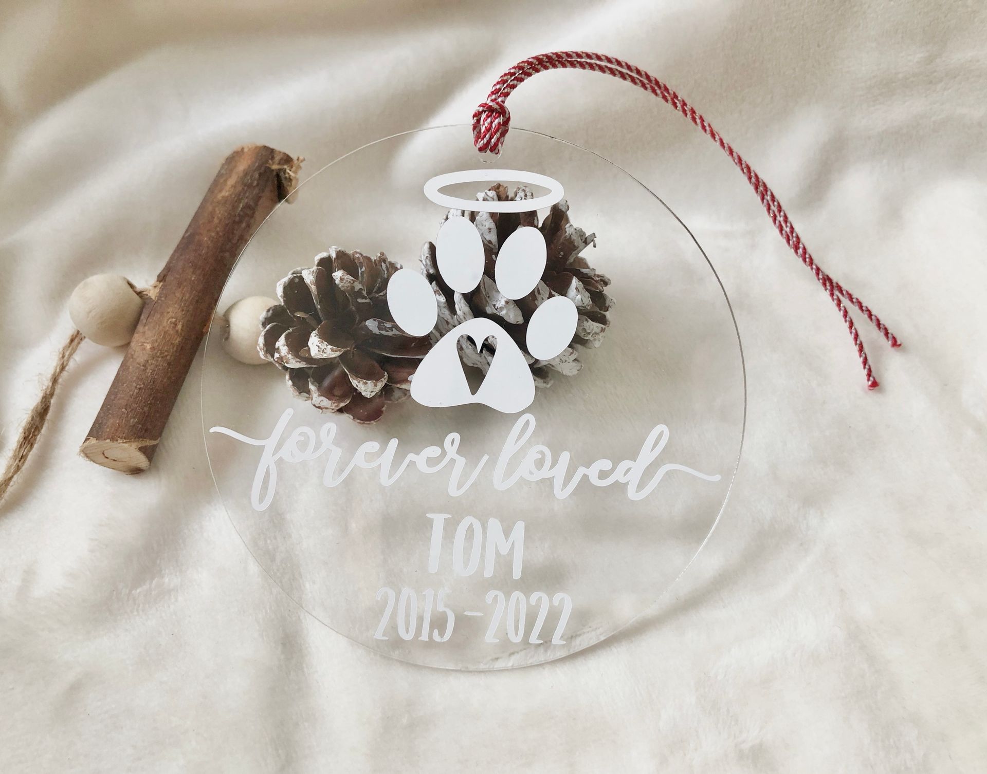 Clear ornament with paw print, angel halo, and 