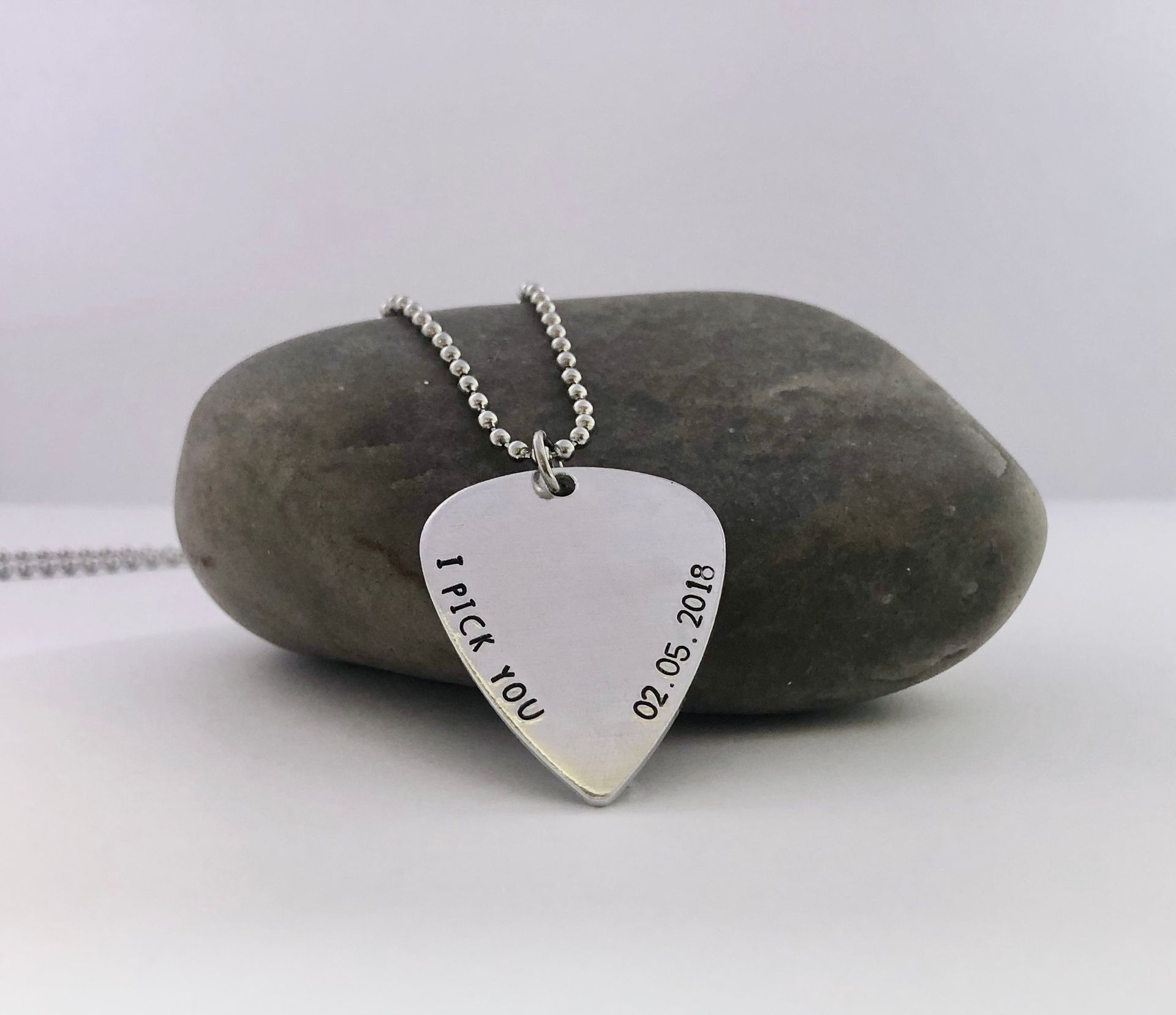 Silver guitar pick necklace with 