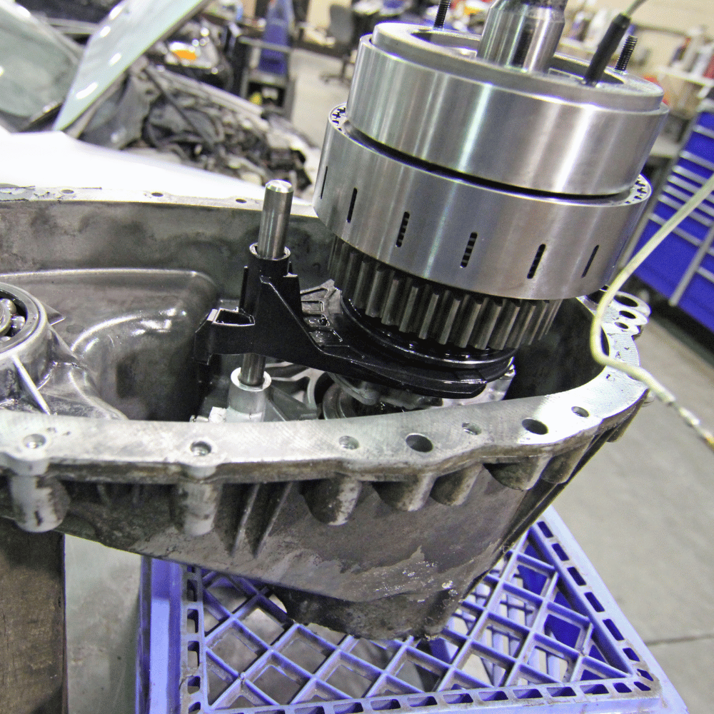 A gearbox is sitting on top of a blue crate
