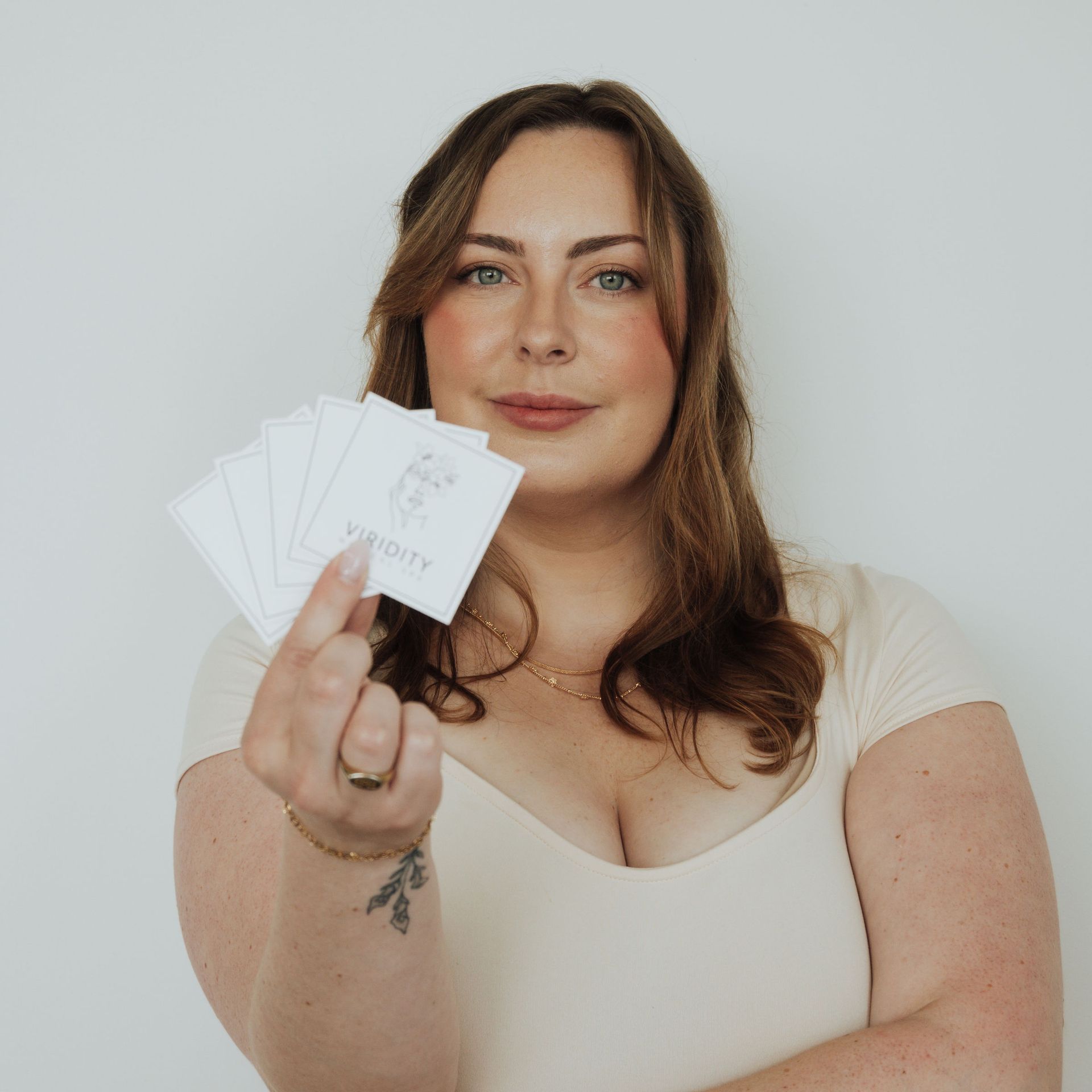 A close up of a woman 's face with a gray background.