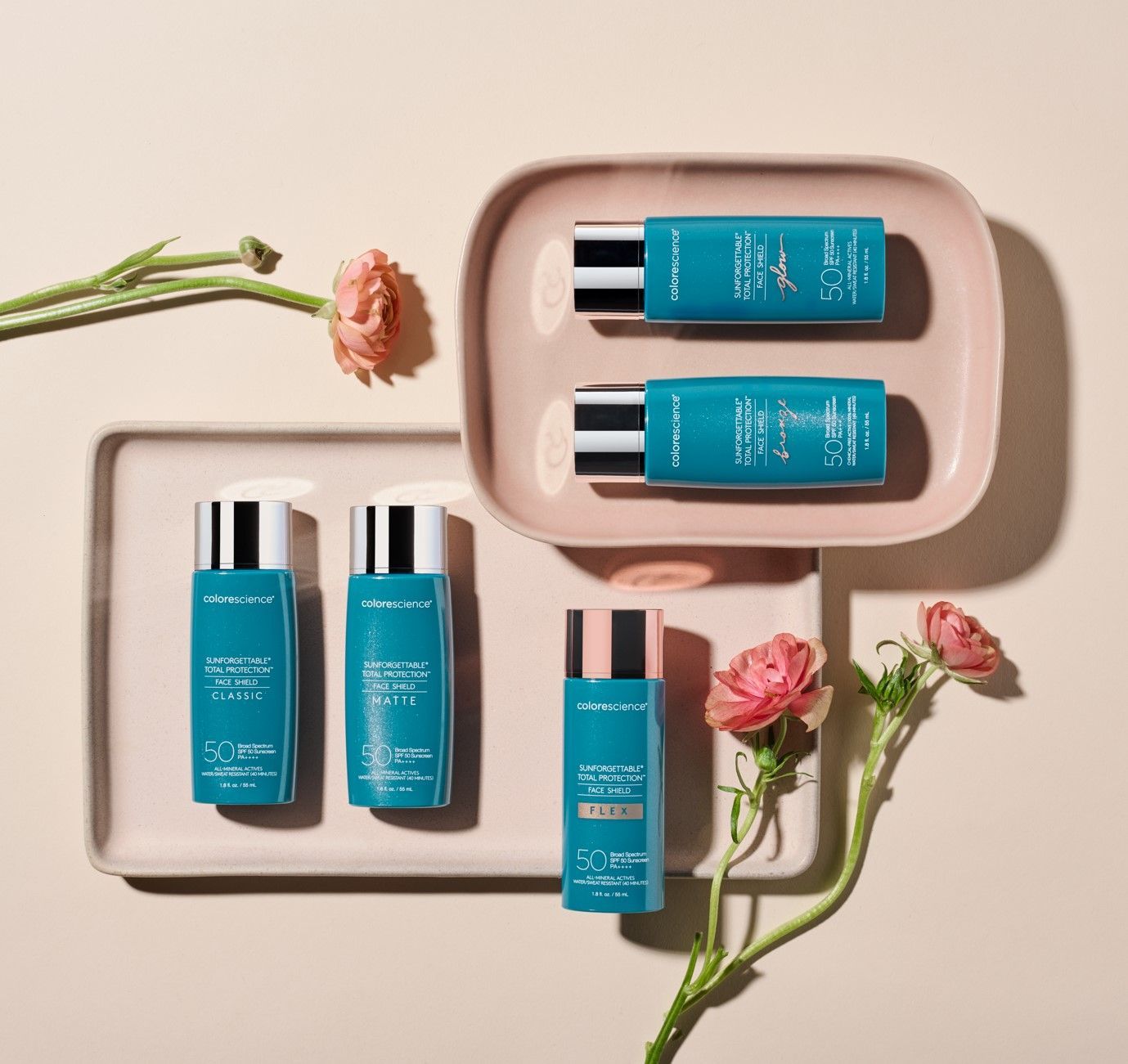 A tray with bottles of cosmetics and flowers on it