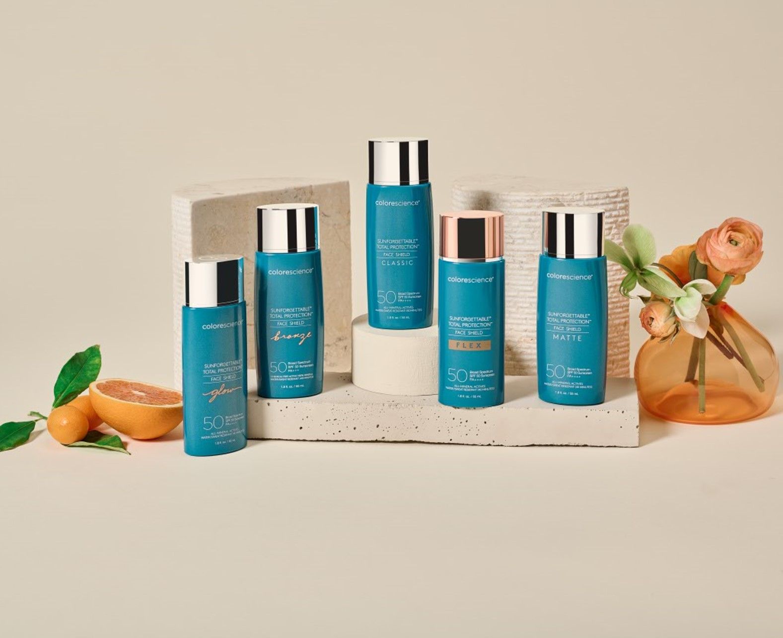 A group of bottles of cosmetics are sitting next to each other on a table.