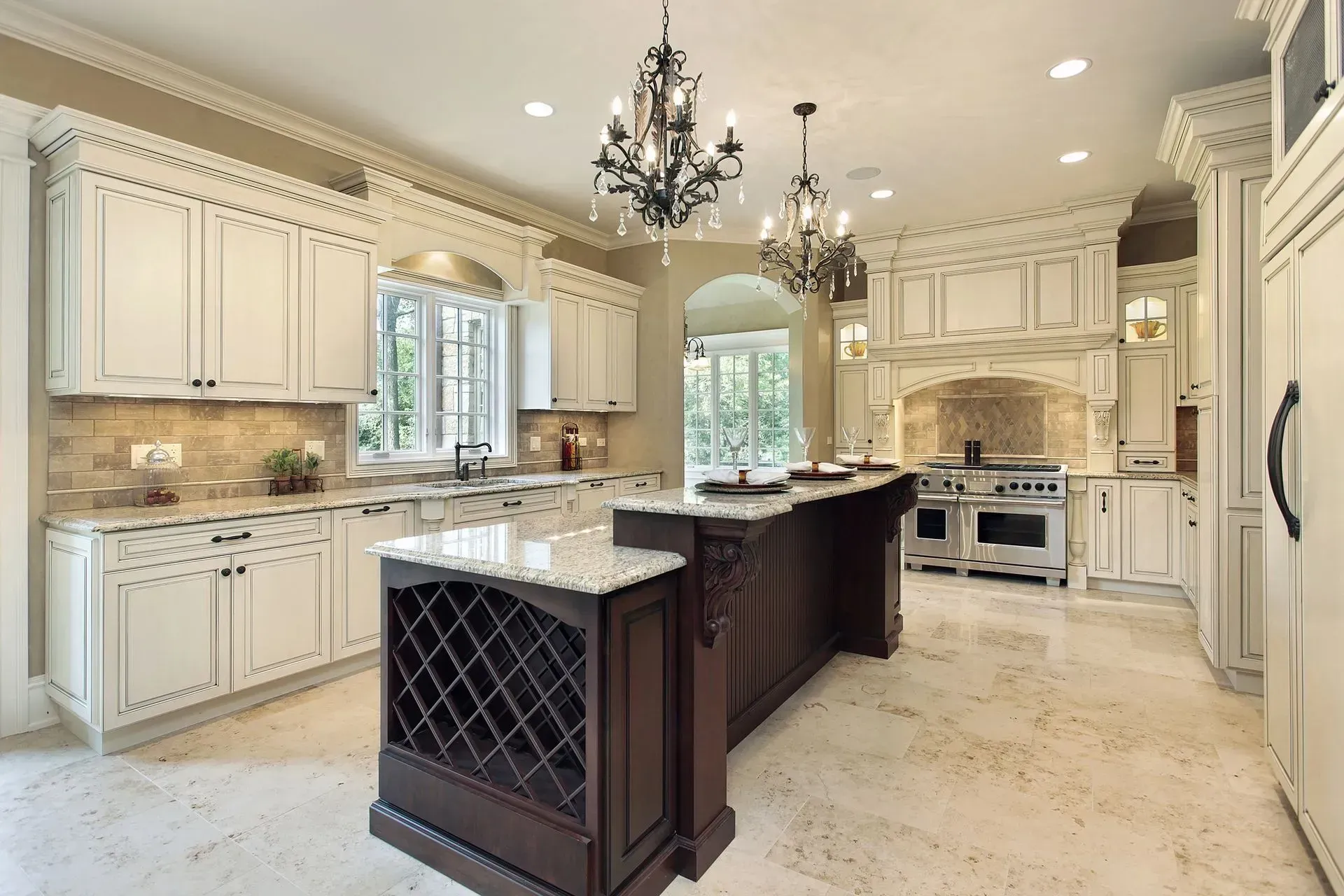 A large kitchen with white cabinets and a large island