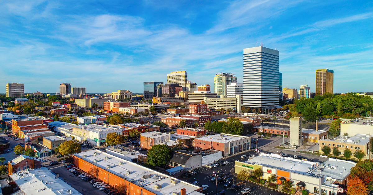 A large house with a large swimming pool in front of it.