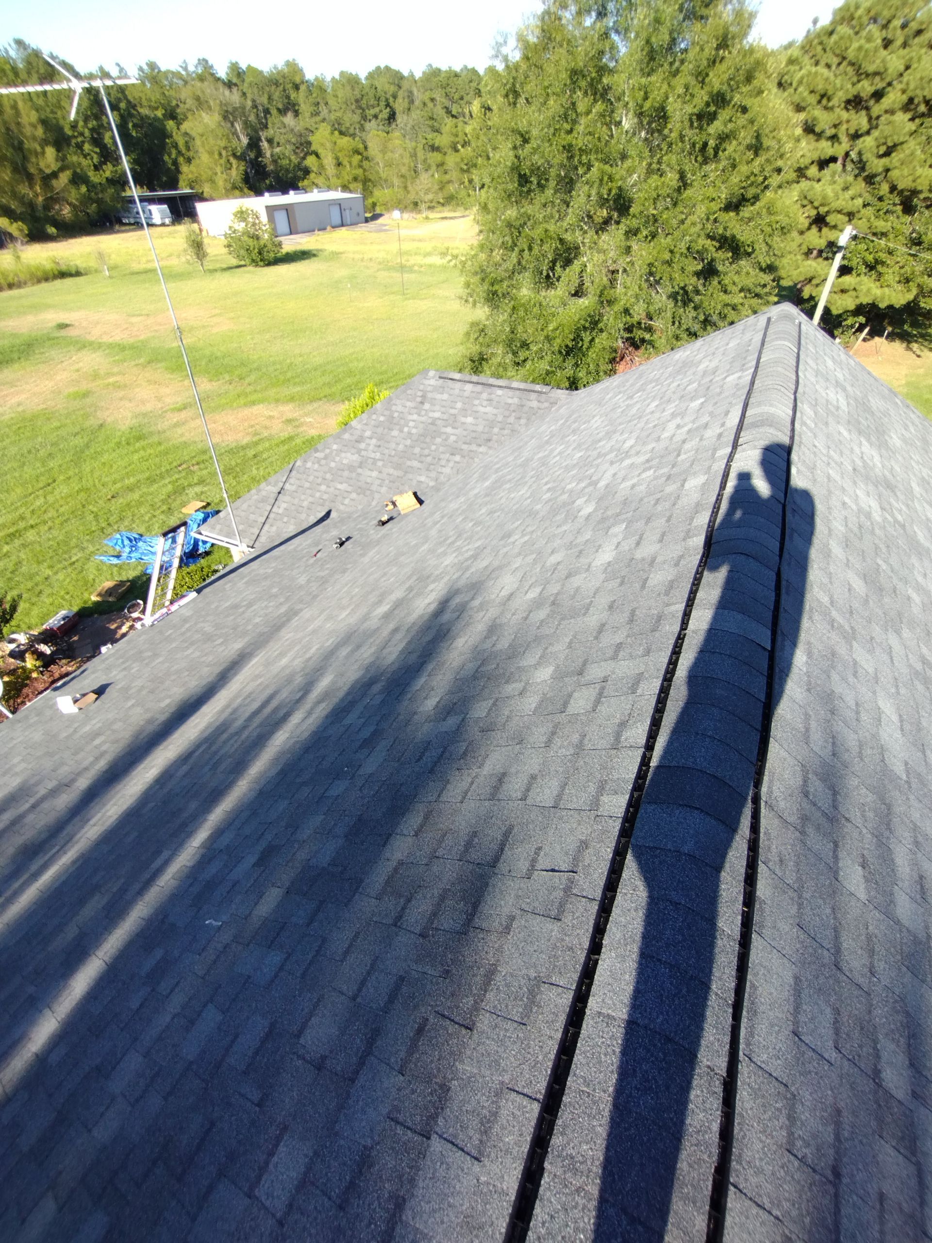 A roof with a shadow of a person on it