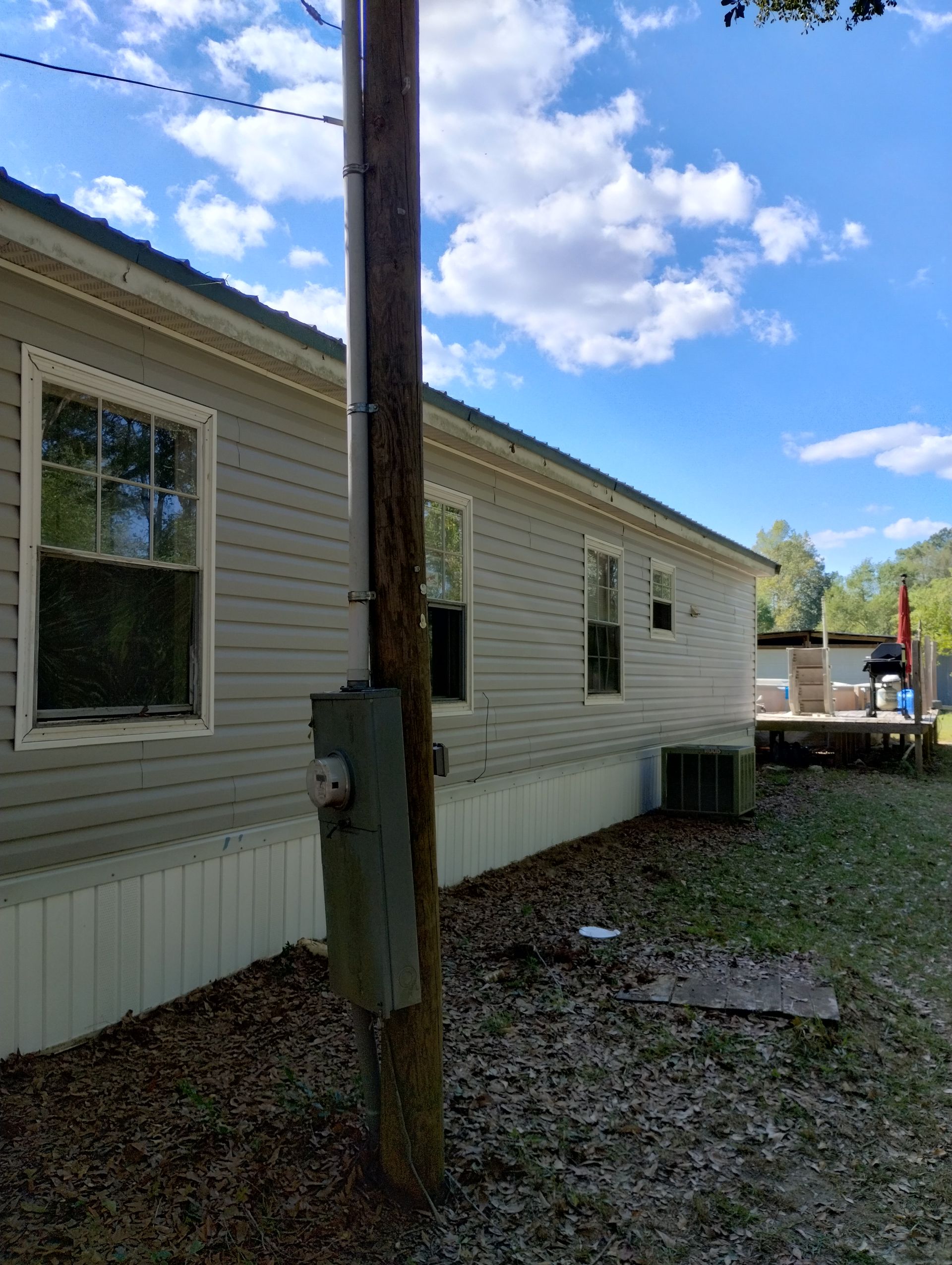 A house with a telephone pole in front of it