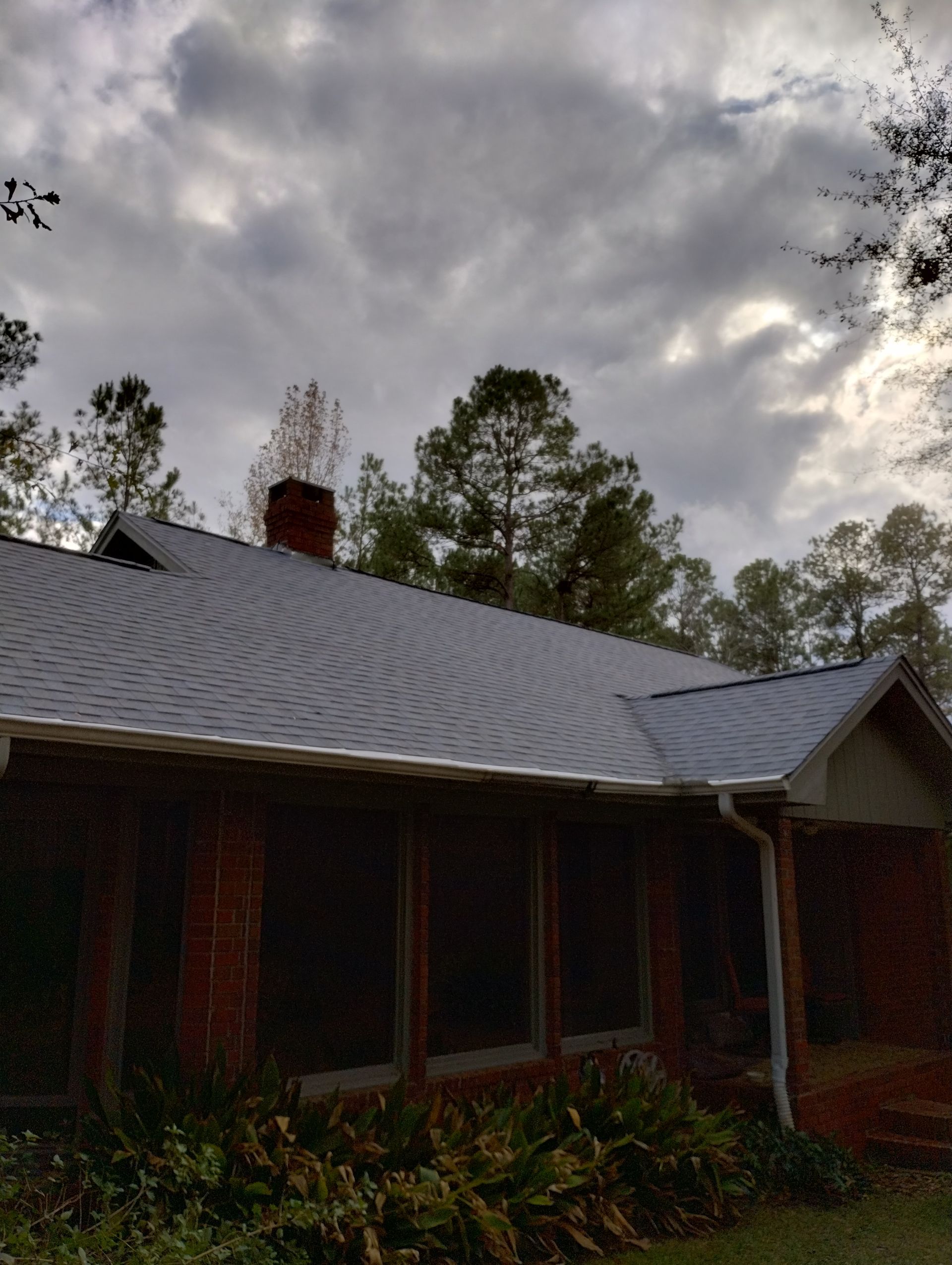 A brick house with a chimney on the roof