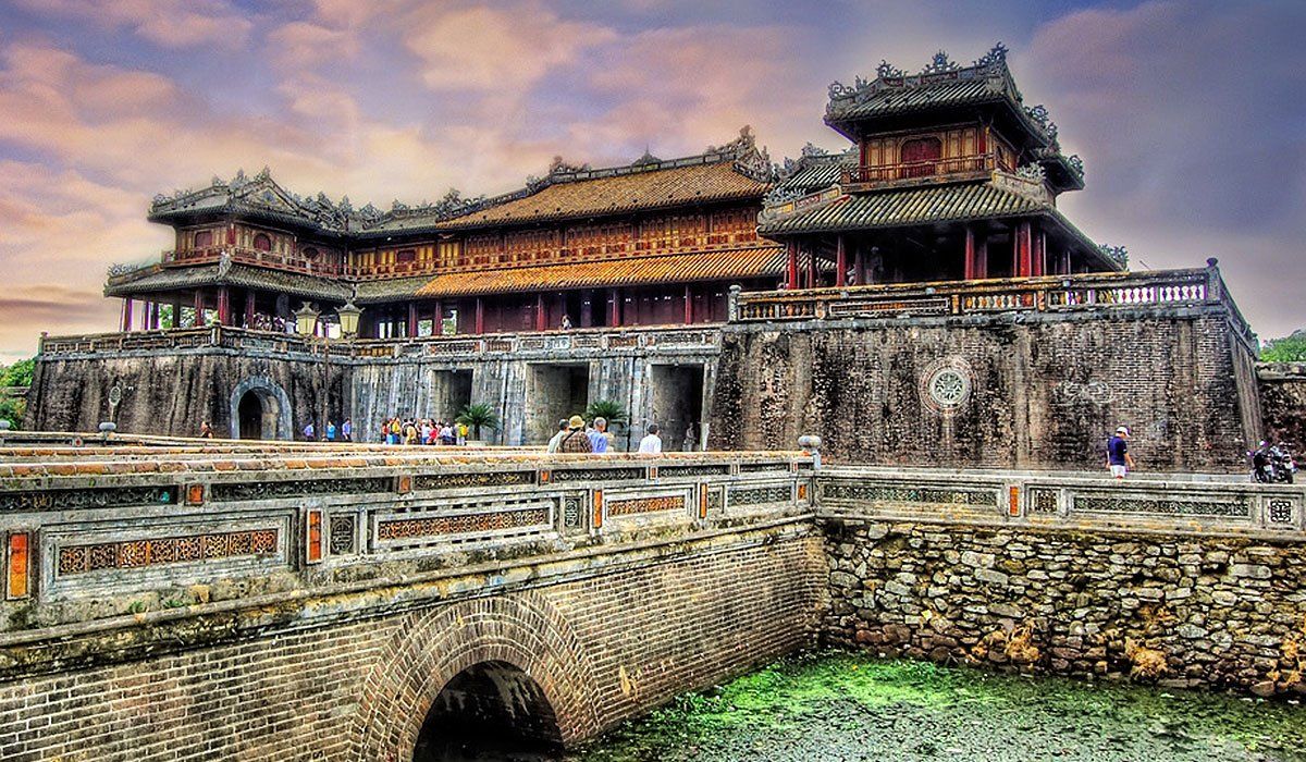 A large building with a bridge in front of it.