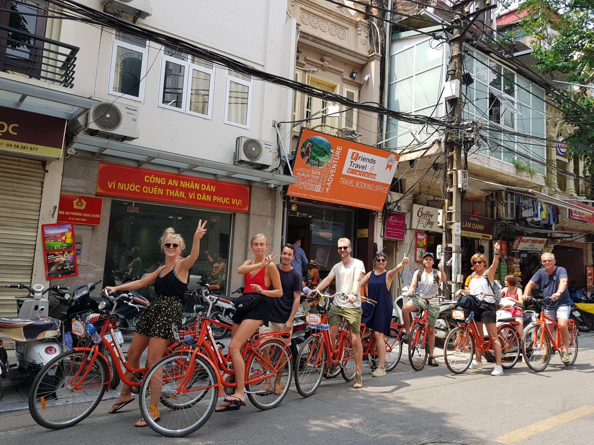 A group of people are riding bicycles down a city street.