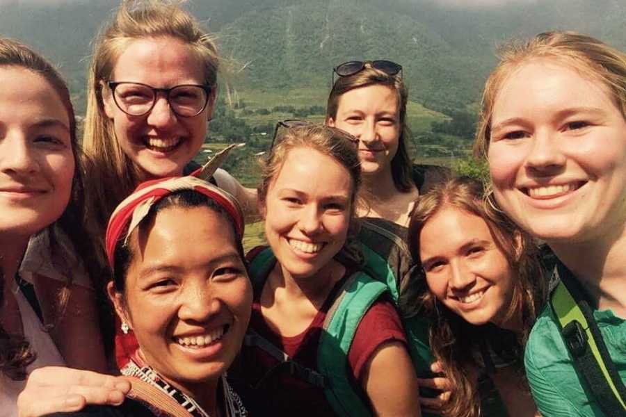 A group of young women are posing for a picture together.