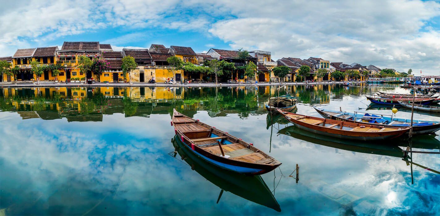 A group of boats are floating on top of a body of water.