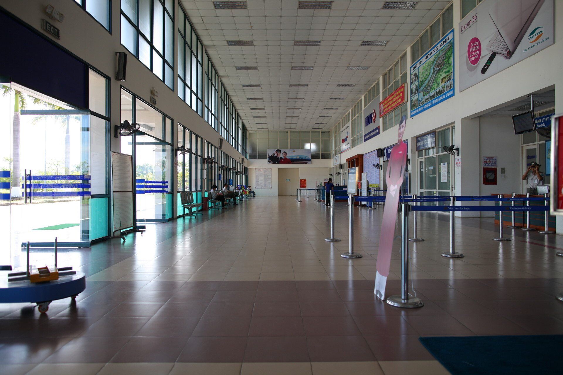 A large empty airport terminal with a lot of windows