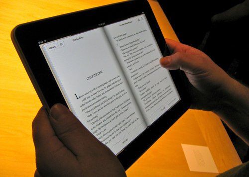 A person is reading a book on a tablet