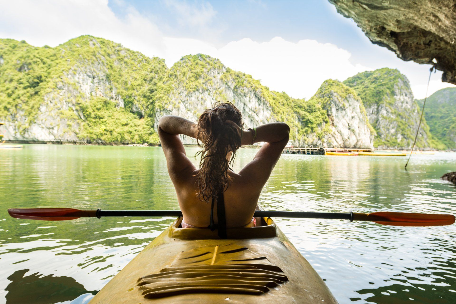 A woman is sitting in a kayak in the water.