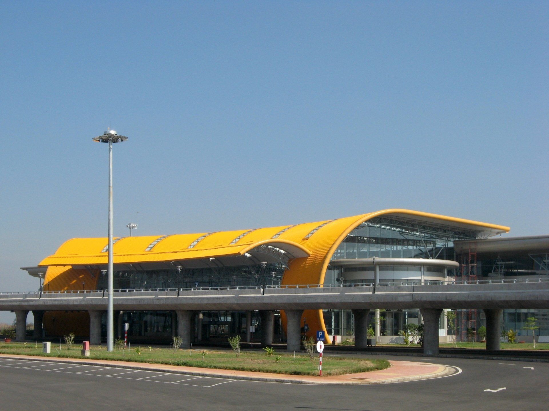 A large yellow building with a blue sky in the background