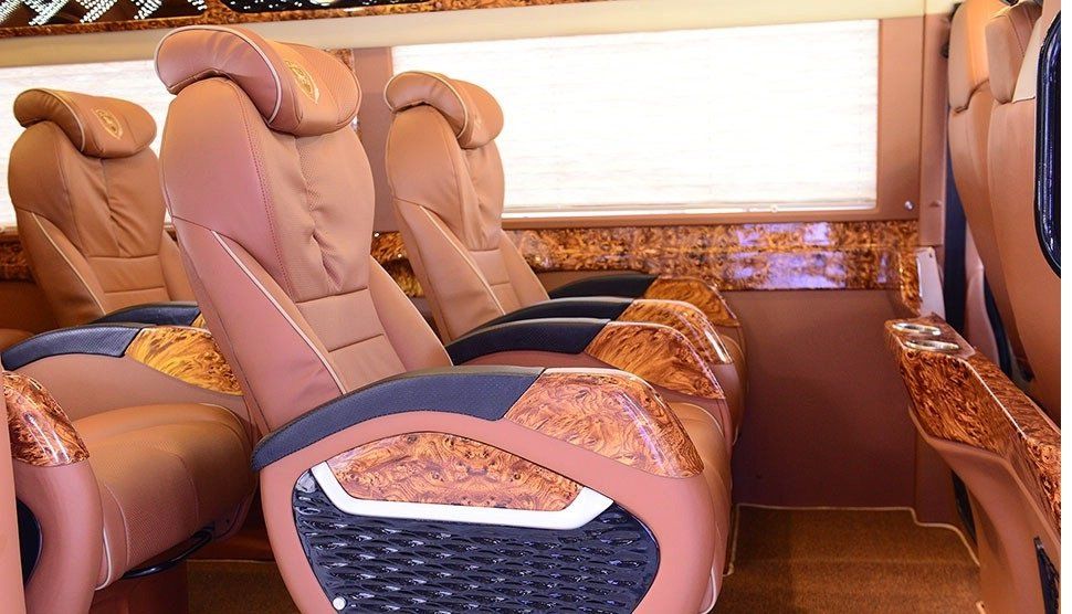 A row of brown leather seats on a bus.