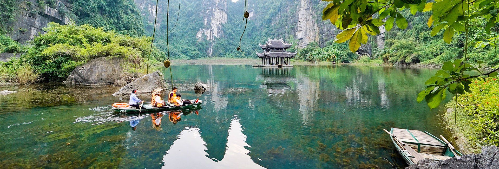 A group of people are rowing a boat on a lake.