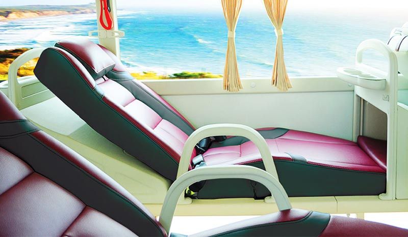 Two chairs are sitting in front of a window with a view of the ocean.