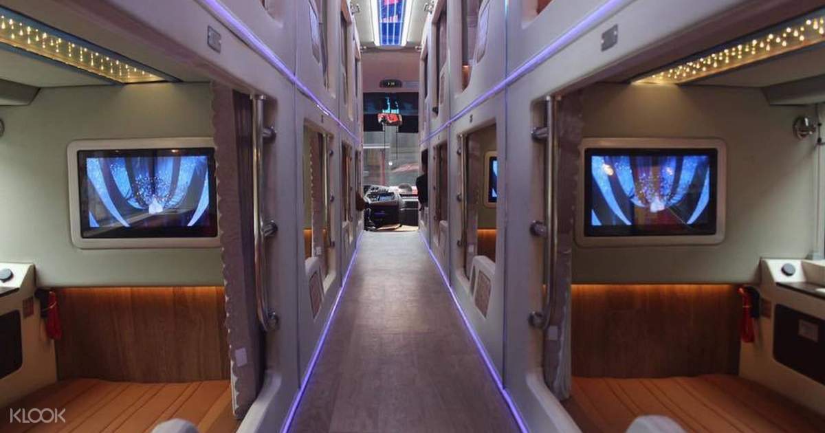 A long hallway with a lot of televisions on the wall.