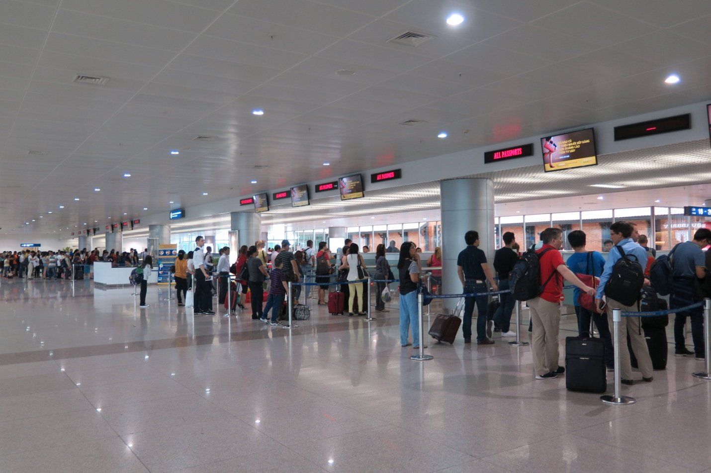 A group of people are standing in a line at an airport.