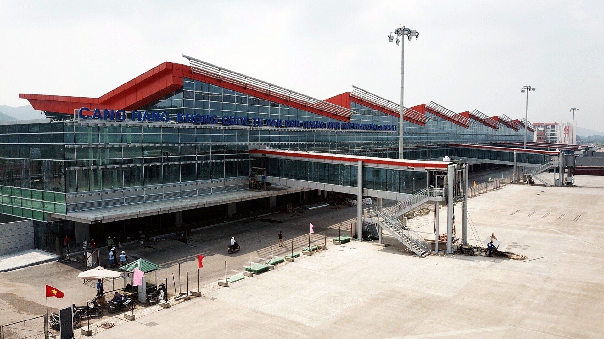 An aerial view of a large airport building with a red roof