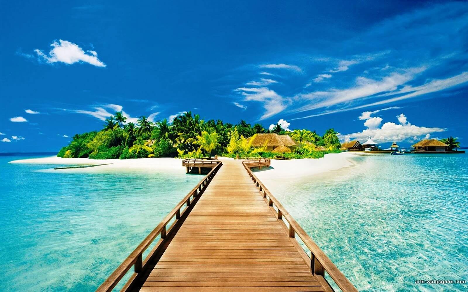 A wooden pier leading to a small island in the middle of the ocean.