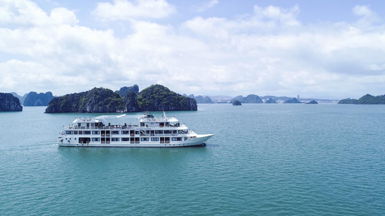 A large white boat is floating on top of a body of water.