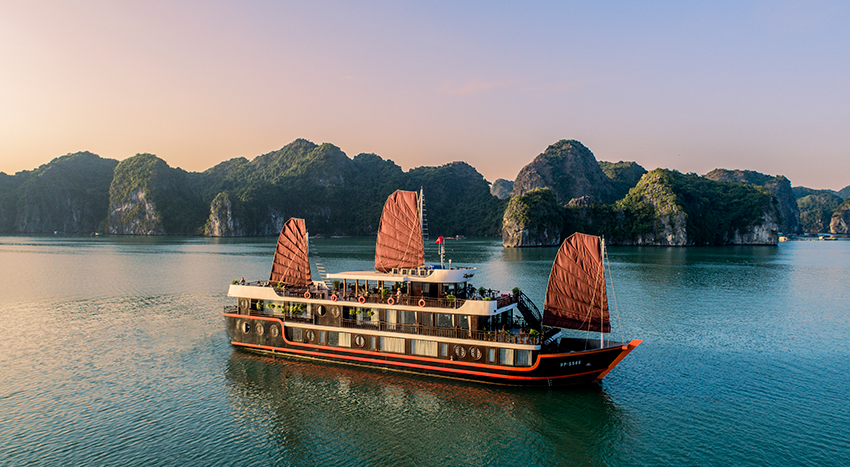 A large boat is floating on top of a body of water.