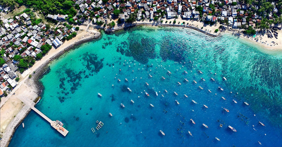 An aerial view of a large body of water with boats in it.