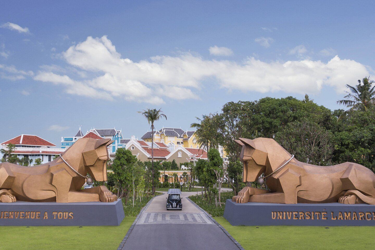A car is driving down a road next to a statue of a dog.