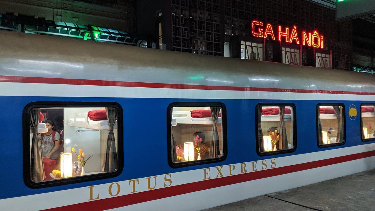 A blue and white train with lotus express written on the side