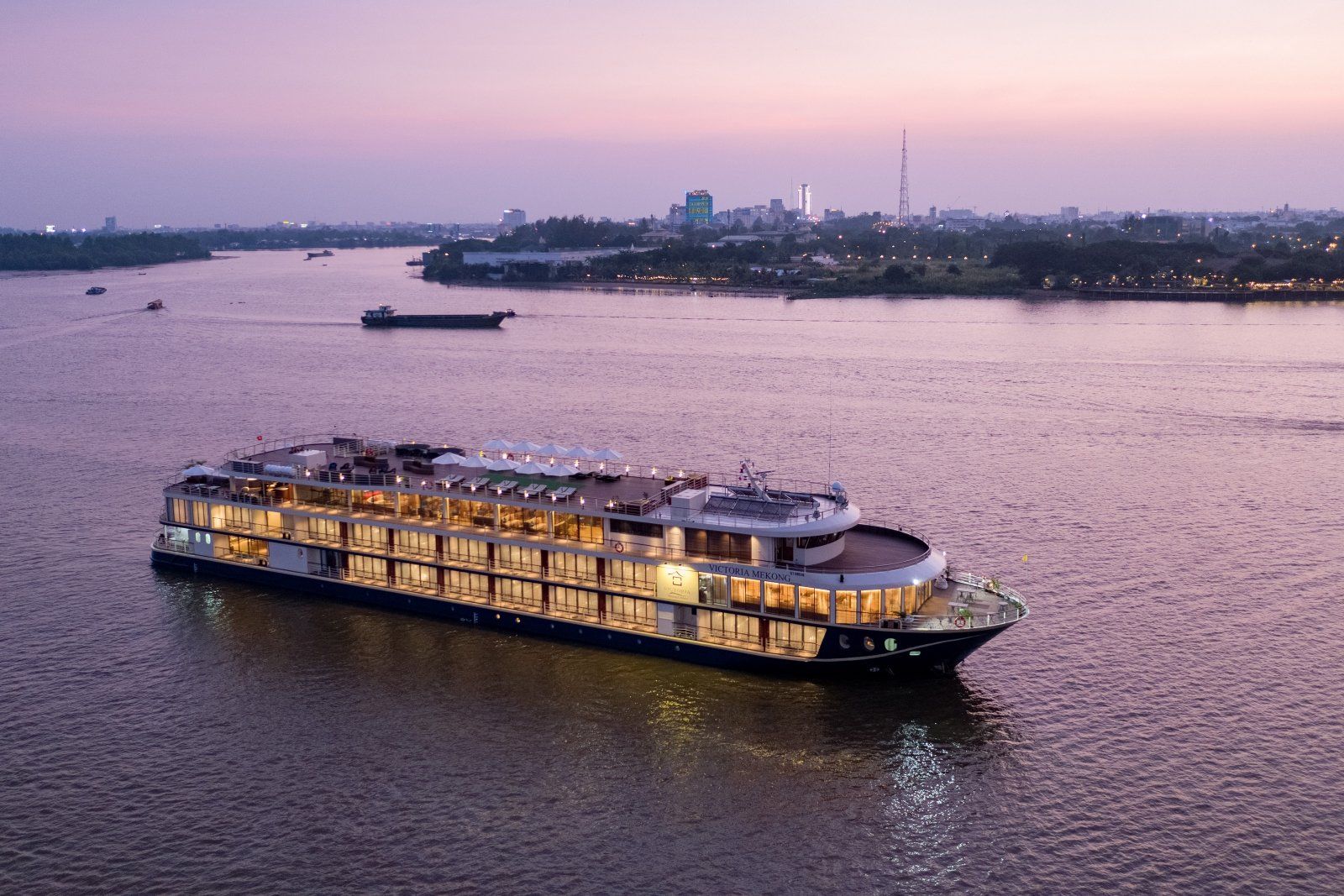 A large cruise ship is floating on top of a large body of water.